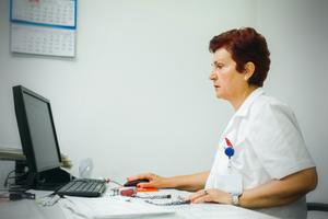 Nurse writing on computer